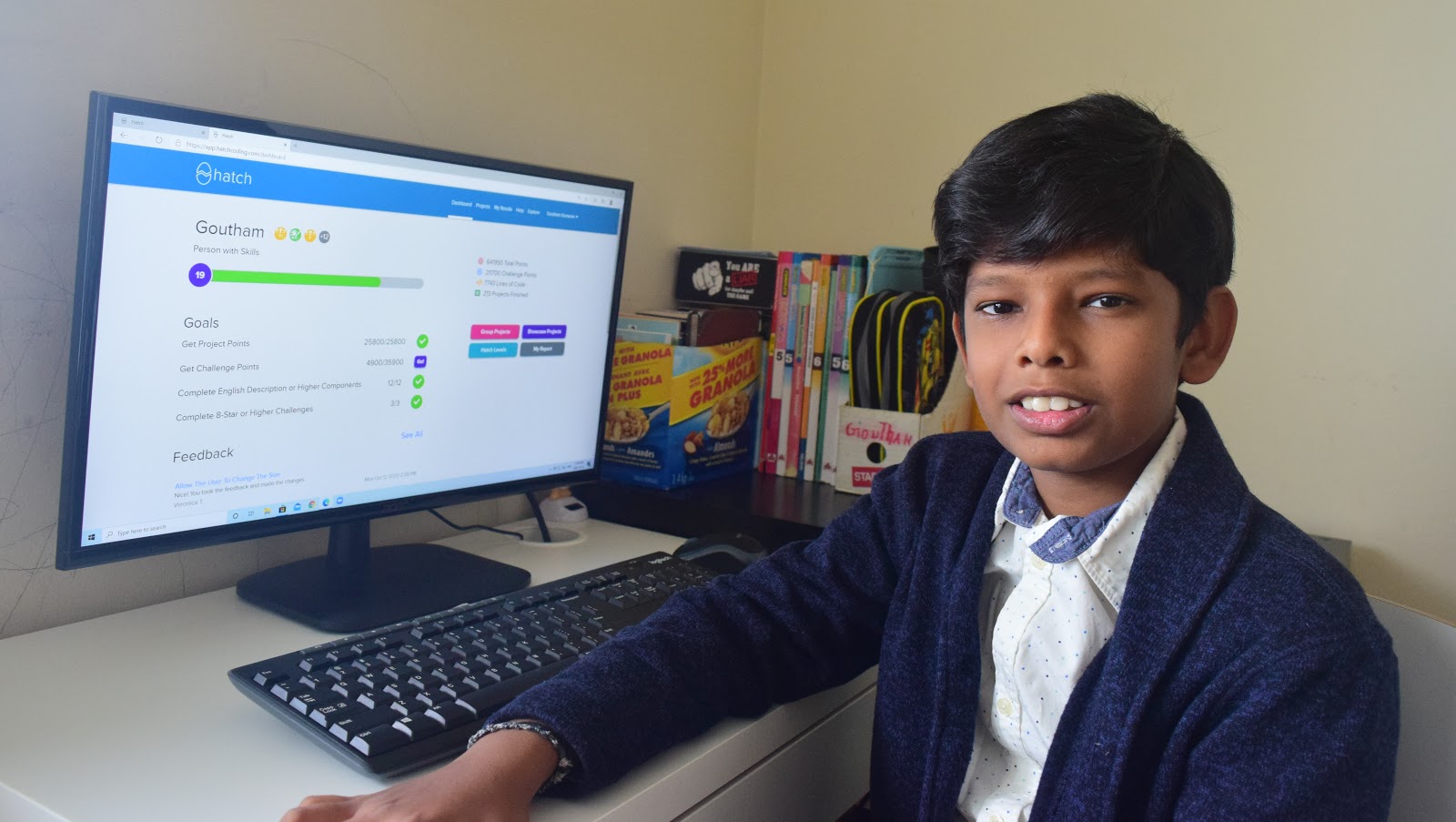 Boy smiling at his computer while working on Hatch Coding's platform